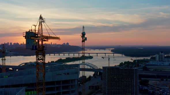 Aerial Horizontal Flight Over Construction Site at Delightful Sunset