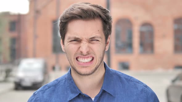 Young Man Upset by Loss while Working in Office