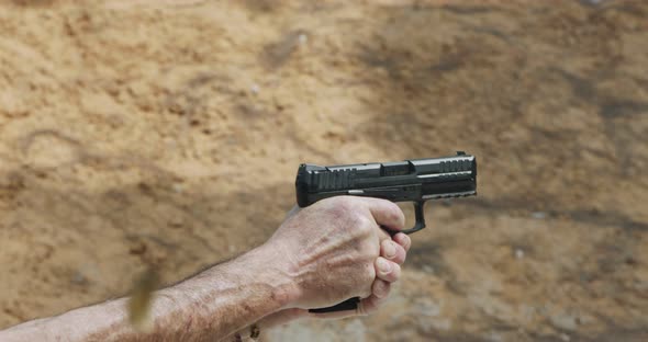 Pistol shooting bullets in slow motion footage. Hand guns in firing range