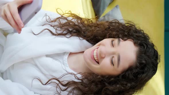 Curly Haired Girl Looking at Camera with Charming Smile Laughing