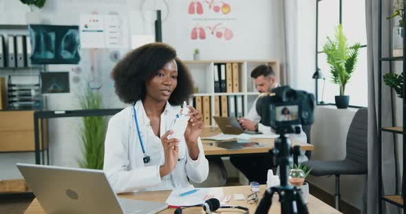 Doctor Recording Video on Camera from Clinic Office and Telling About Antibacterial Spray