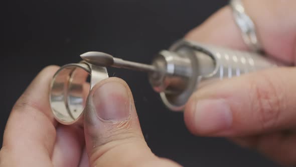 Hands of Jeweler Polishing Metal Ring