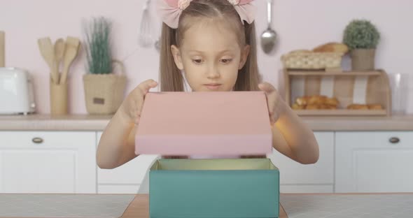 Portrait of Excited Little Girl Opening Gift Box with Surprised Facial Expression, Pretty Brunette