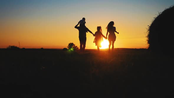 Family Silhouette with Sunset