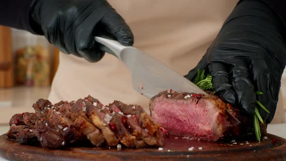 Unrecognizable Chef Cutting Beef Meat Cooking Beefsteaks In Kitchen Cropped