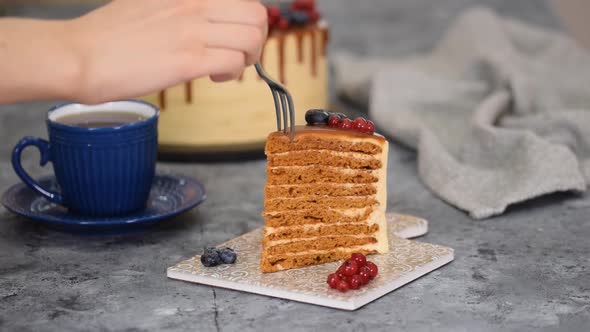 Piece of Layer Caramel Cake with Cream and Fresh Berries