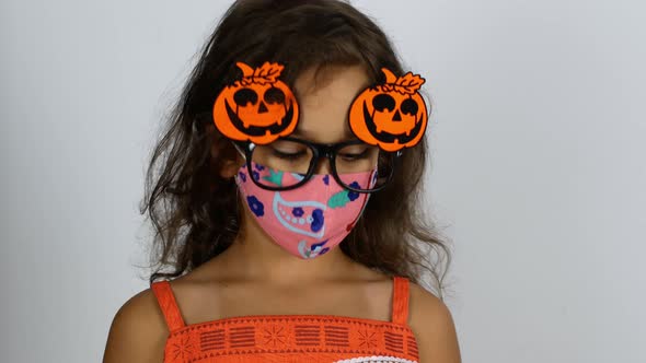 On Halloween, children celebrate the holiday and dress up in festive costumes.