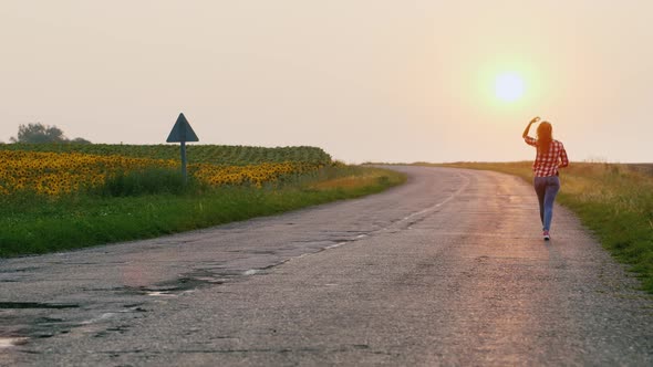 A Young Woman Walks Forward on Her Way To the Rising Sun.