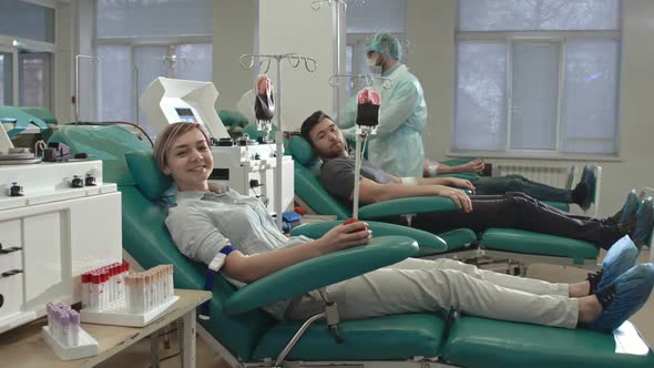 Young Blood Donors Looking at Camera with Smile