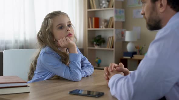 Obstinate Long-Haired Daughter Disputing With Father About Smartphone Addiction