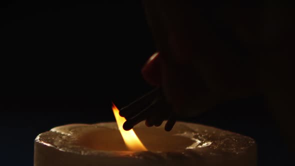 Hand lightening sparklers from candle