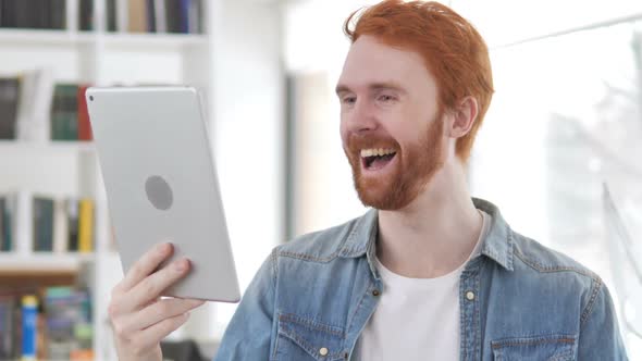 Online Video Chat on Tablet By Casual Redhead Man