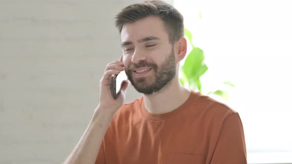 Young Man Talking on Phone Discussion