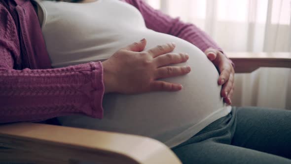 Happy Pregnant Woman and Expecting Baby at Home