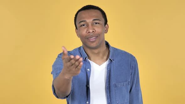 Flying Kiss By Young African Man, Yellow Background