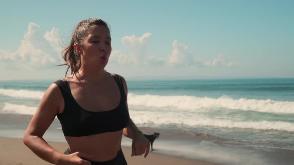 Woman is Training and Losing Weight Running at Morning on Ocean Shore