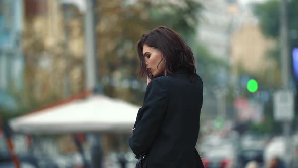 a Woman in a Business Suit Walks Around the City