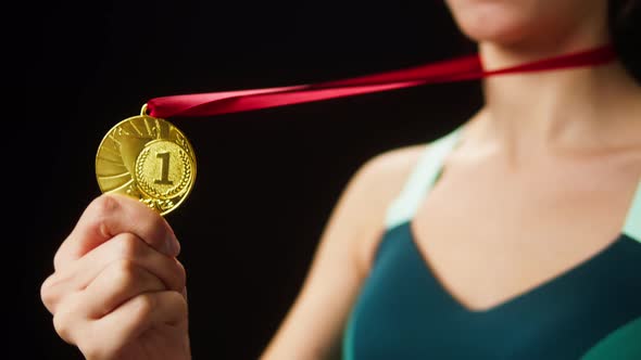 Professional Sportswoman Winner Holding Gold Medal Closeup