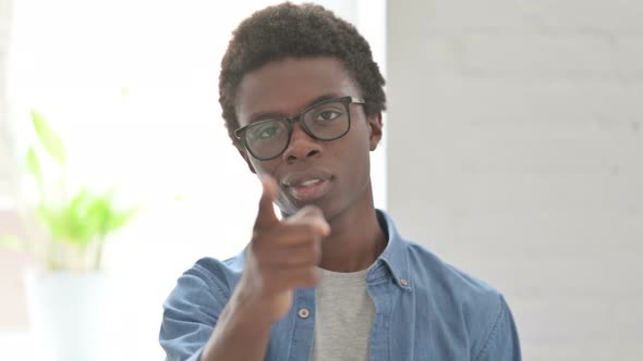 Portrait of Young African Man Pointing at the Camera and Inviting