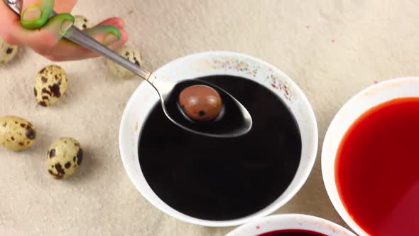 a Young Caucasian Child Paints Quail Eggs with a Metal Spoon