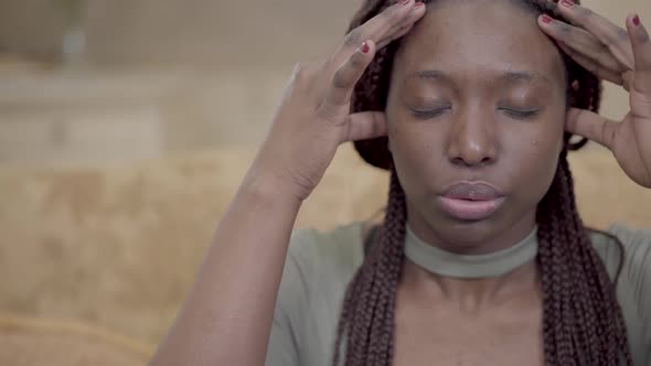 Nervous African American American Woman with Dreadlocks Massaging Her Head with Fingers. Lady Has