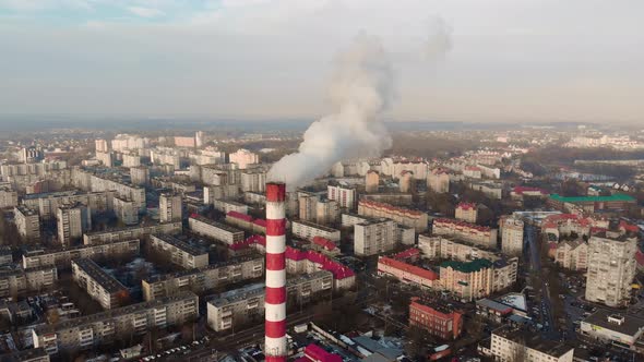 Approaching Industrial Pipe with Smoke in Modern City