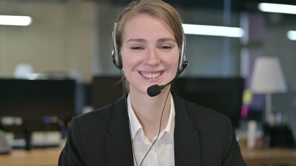 Portrait of Cheerful Young Businesswoman Wearing Head Phones