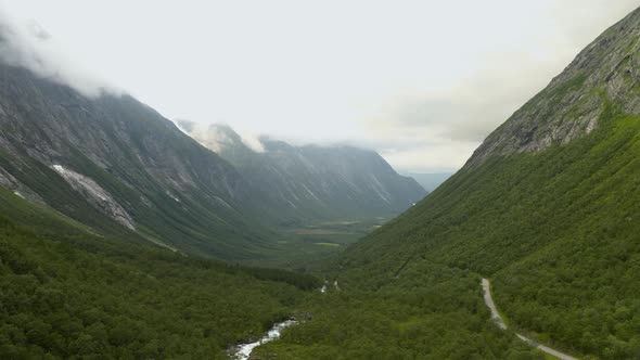 Winding Road Of Trollstigen Mountain Pass Amidst The Green Forest In Rauma Municipality, Norway. aer