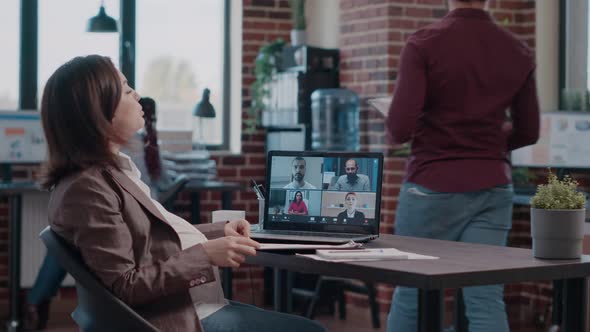 Pregnant Woman Talking to Colleagues on Video Call