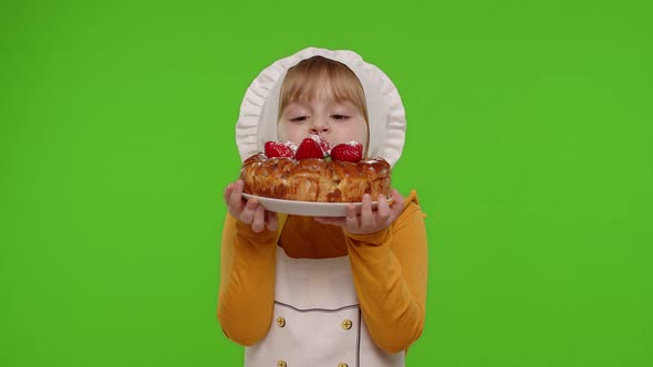 Child Girl Kid Dressed As Cook Chef Sprinkle Strawberry Cake with Icing Sugar Chroma Key Background