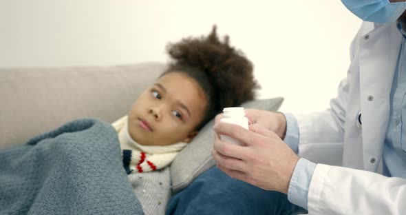 Pediatrician at Home Visiting Helping Little Black Girl