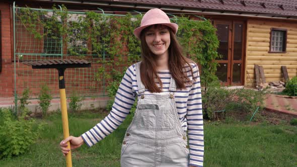 Portrait of Caucasian Young Beautiful Woman in Cap Smiling Cheerfully to Camera