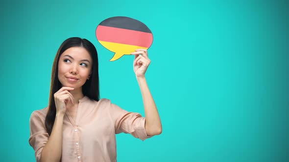 Curious Woman Holding German Flag Sign, Learning Language, Education Abroad