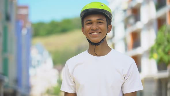 Excited Afro-American Male Teen in Protective Helmet Smiling, Cycling Hobby