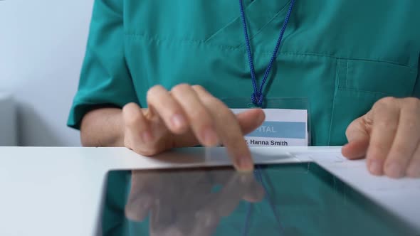 Senior Female Therapist Typing on Laptop, Checking Patient Examination Results