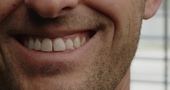 Man with facial hair close up smiling