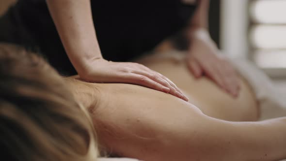 Manual Therapy for Health Spinal Professional Chiropractor is Massaging Female Body in Clinic