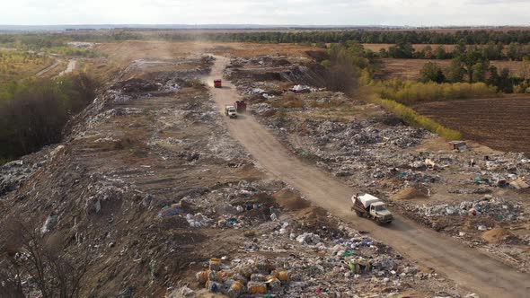 Aerial View of Large Garbage Pile at Sorting Site. Trucks Bring Waste To a Garbage Pile in Trash