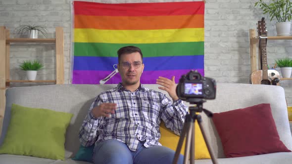 Portrait Man Blogger Middleaged in the Shirt on the Background of the Flag of the LGBT Records Video