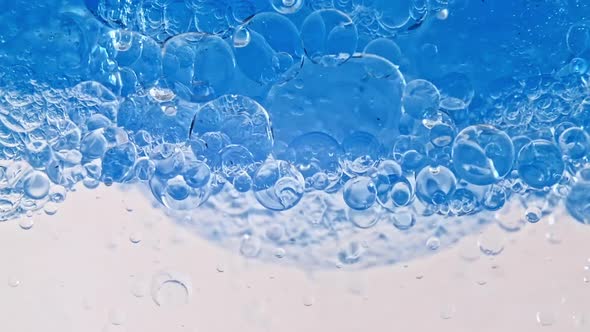 Macro Shot of Various Air Bubbles in Water Rising Up on Light White Background