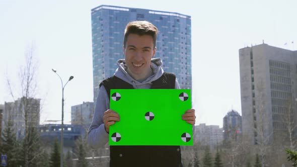 Happy Groom Invites Everyone To Wedding, Holding Green Screen Banner for Text 