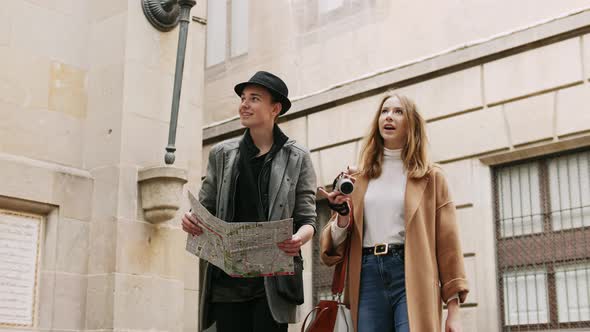 Two Stylish Friends Talking During Walk at the Street