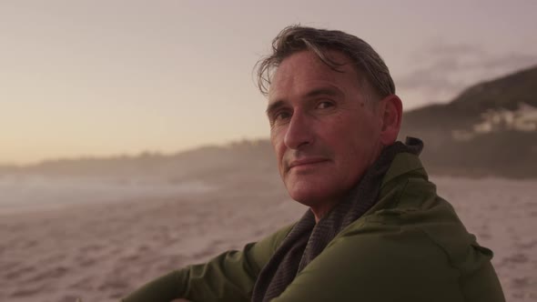 Active senior sitting on beach