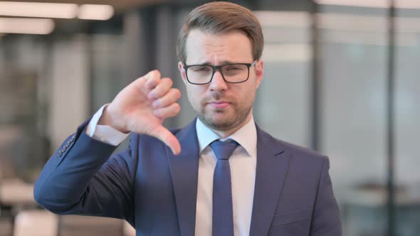 Portrait of Thumbs Down Gesture by Businessman