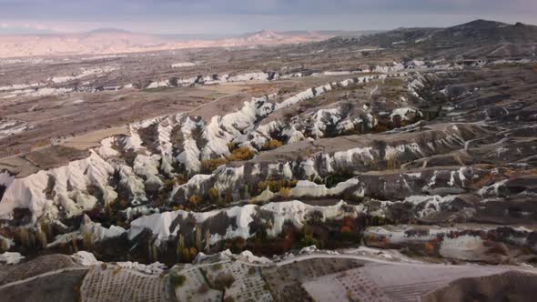 Aerial Drone Footage of Valley with Sandstone Mountains and Volcanic Rocks Forming Gorges