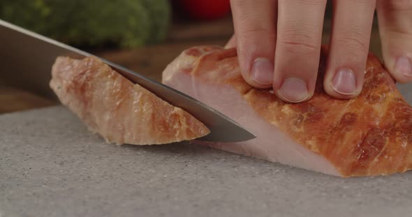 Slicing Meat. With A Sharp Knife Cuts Thin Slices Of Ham.