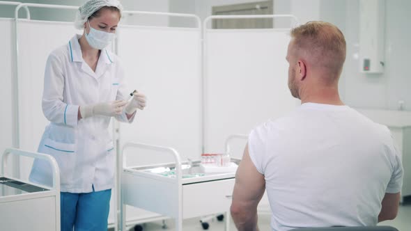 Female Doctor is Injecting a Man with Coronavirus Vaccine