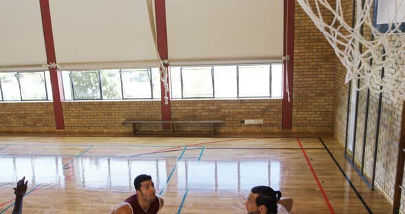 Basketball players playing in the court