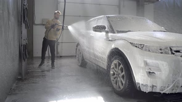 Car Washing at Selfservice Station Hose for Spraying Soap Foam in a Garage