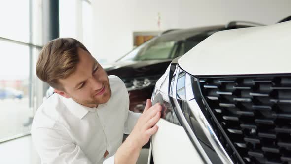 A Man Examine Vehicle Before Making Purchase